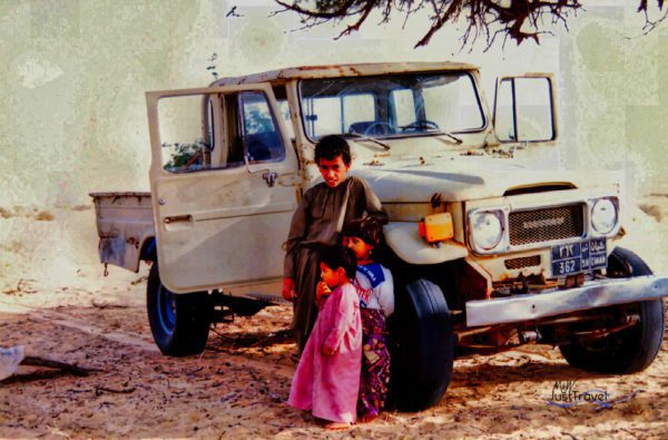 Kinder vor einem Pickup in den Wahiba Sands, Oman